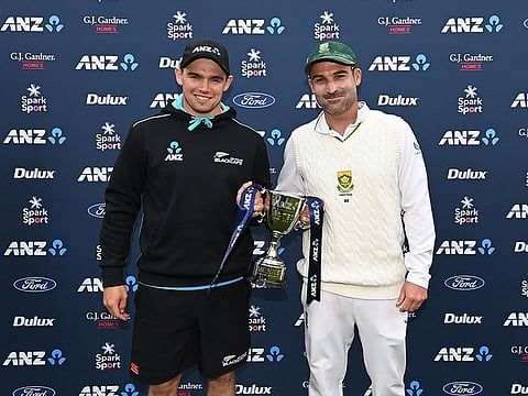 Honours shared: Tom Latham (left) and Dean Elgar, the New Zealand and South Africa captains respectively, pose with the winners' trophy after the series ended 1-1.
