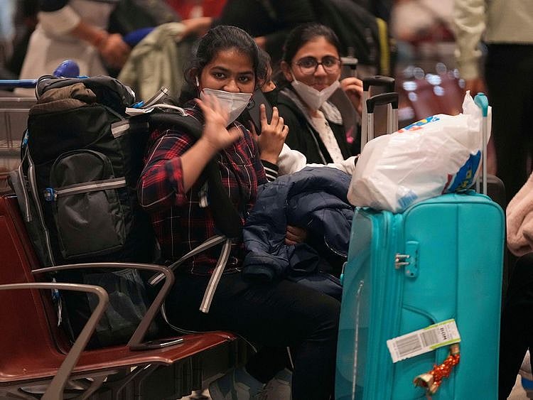Indian students wave as a batch of 250 Indian nationals stranded in Ukraine arrived from Bucharest at Chhatrapati Shivaji Maharaj International Airport in Mumbai.