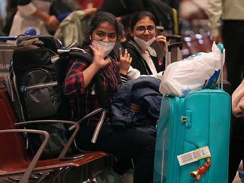 Indian students wave as a batch of 250 Indian nationals stranded in Ukraine arrived from Bucharest at Chhatrapati Shivaji Maharaj International Airport in Mumbai.