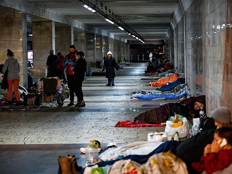 Civilians take shelter at an underground metro station in Kyiv on March 2, 2022. On the seventh day of fighting in Ukraine Russia claims control on March 2, 2022 of the southern port city of Kherson, street battles rage in Ukraine's second-biggest city Kharkiv, and Kyiv braces for a feared Russian assault. 