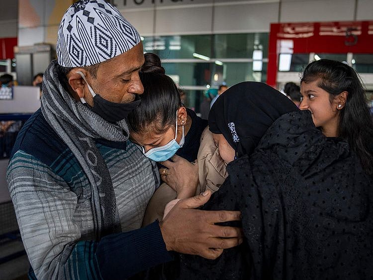  Parents hug Iqra Praveen, an Indian student studying in Ukraine who fled the conflict, after she arrived at Indira Gandhi International Airport in New Delhi, on Wednesday.
