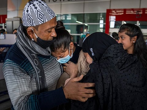  Parents hug Iqra Praveen, an Indian student studying in Ukraine who fled the conflict, after she arrived at Indira Gandhi International Airport in New Delhi, on Wednesday.
