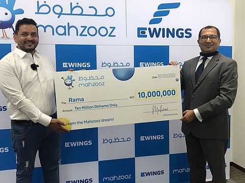 Indian cook Rama receiving the Dh10 million cheque from Farid Samji, CEO of Ewings.