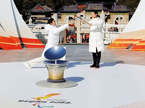 Participants take part in the flame lighting ceremony for the Winter Paralympic Games at the Temple of Heaven in Beijing on Wednesday.