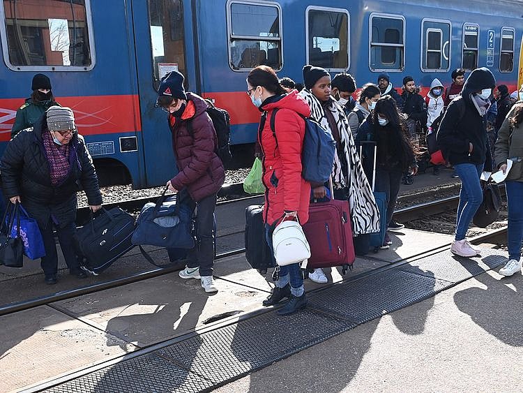 Refugees arriving from Ukraine including African and Indian students of Kyiv University get off a train at the railway station in the Hungarian-Ukrainian border town of Zahony.