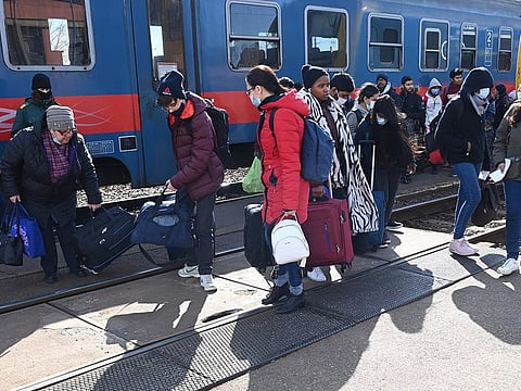 Refugees arriving from Ukraine including African and Indian students of Kyiv University get off a train at the railway station in the Hungarian-Ukrainian border town of Zahony.