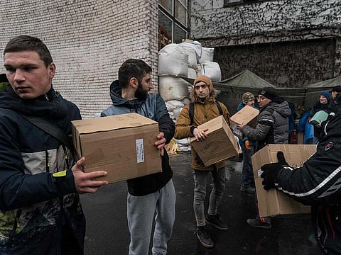 Volunteers unload stuff received from across the country at a charitable fund centre set up to oversee the distribution of humanitarian supplies to those in need, servicemen and the displaced, in the Ukrainian city of Dnipro, the industrial hub, which sits on the western side of the Dnieper river and divides east and central Ukraine, on March 2, 2022.