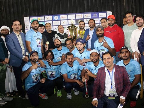 B4$ cricket team players celebrate after receiving the Chinar Super League winner's trophy during the closing ceremony in Ajman. 