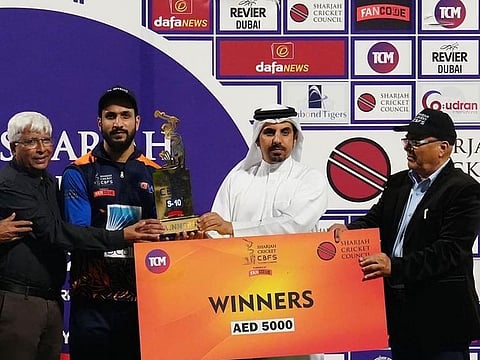MGM captain Adel Malik receives the trophy from Waleed Bukhatir and Mazhar Khan.