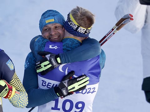 Gold medalist Vitalii Lukianenko of Ukraine celebrates with Bronze medalist Dmytro Suiarko of Ukraine after competing in the Para Biathlon Men's Sprint Vision Impaired at the National Biathlon Centre, Zhangjiakou, China during the Beijing 2022 Winter Paralympic Games. 