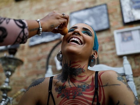 Marian Leyva, 21, reacts while preparing for a photo shoot of Erias (A community of tattooed women) in Havana, Cuba.