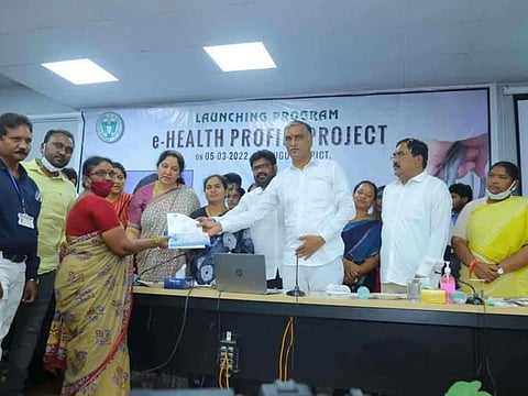 Telangana Health Minister T Harish Rao handing over e-Health cards to beneficiaries.