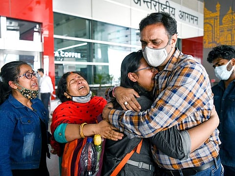 An Indian student breaks down while meeting her family members on arrival at Indira Gandhi International (IGI) Airport in New Delhi on Sunday after being evacuated from Ukraine. 
