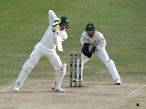 Australia's Alex Carey (left) plays a shot during the fourth day play of the first Test cricket match between Pakistan and Australia at the Rawalpindi Cricket Stadium in Rawalpindi.