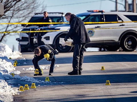 Police investigate a shooting outside of East High School in in Des Moines, Iowa, on Monday, March 7, 2022.