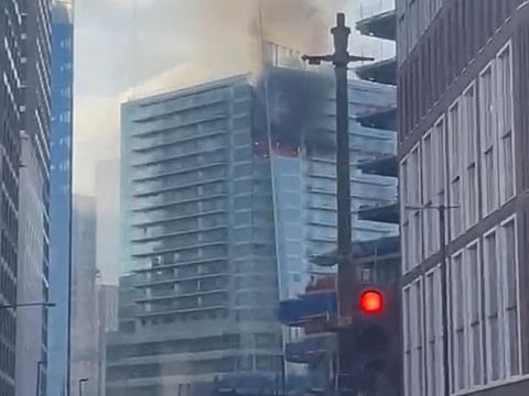 Smoke billows from a high-rise building after a fire broke out on Whitechapel High Street, in London, Britain March 7, 2022 in this still image taken from video obtained from social media. 