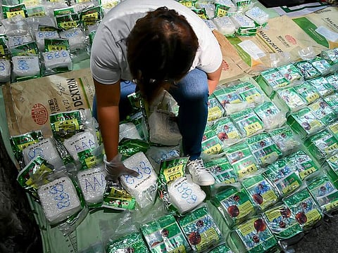 A man arranges bags of seized suspected methamphetamine in Valenzuela city, Philippines.