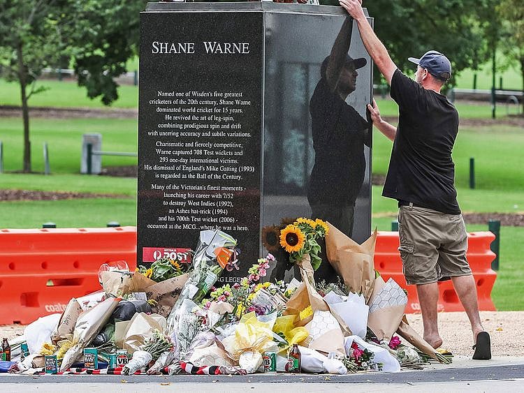 A mourner pays respects to Shane Warne outside Melbourne Cricket Ground 
