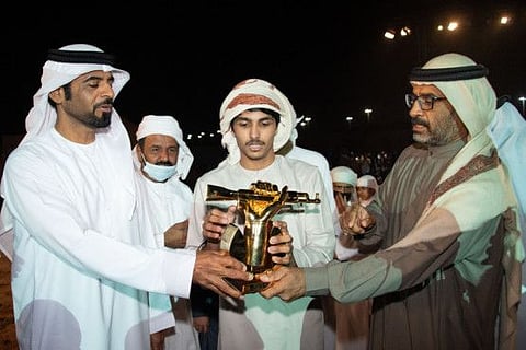 Awad Al-Amiri with the winner's trophy.