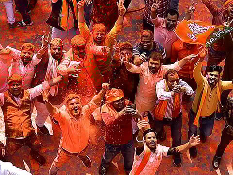 Supporters of India's Bharatiya Janata Party (BJP) celebrate outside the party office in Lucknow on March 10, 2022, on the day of counting of votes for the Uttar Padesh state asembly elections. 