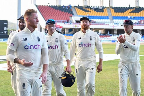 Joe Root (right) cheers on Ben Stokes, Ollie Pope, and Jonny Bairstow of England while walking off the field at the end of the 3rd day of the 1st Test against West Indies at Vivian Richards Cricket Stadium in North Sound, Antigua and Barbuda.