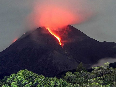 Lava flows down from the crater of Mount Merapi seen from Cangkringan village in Sleman, Yogyakarta, early Friday, March 11, 2022.  