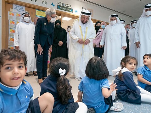 His Highness Dr Sheikh Sultan bin Muhammad Al Qasimi interacts with the children at Victoria International School of Sharjah on Thursday.