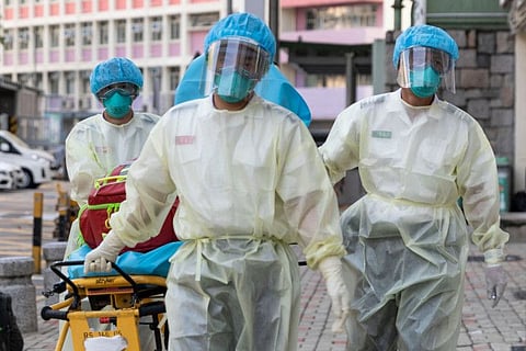This file photo taken on August 23, 2020 shows medical staff wearing personal protective equipment (PPE) as a precautionary measure against the COVID-19 coronavirus approaching a care home in Hong Kong.