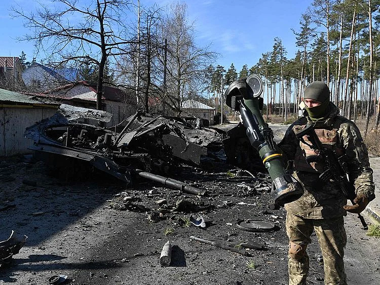 A Ukrainian soldier holds a Next Generation Light Anti-tank Weapon (NLAW) that was used to destroy a Russian armoured personal carrier (APC) in Irpin, north of Kyiv, on March 12, 2022.  
