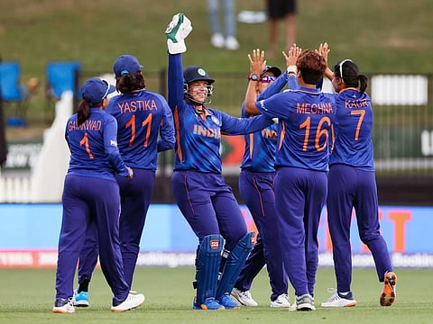 India's Meghna Singh and Richa Ghosh celebrate the dismissal of West Indies Chedean Nation during the ICC Women's World Cup 2022 match at Seddon Park, in Hamilton.