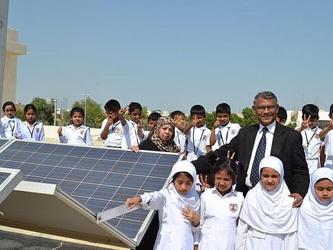 Mir Anisul Hasan with students after the installation of solar panels at the school.