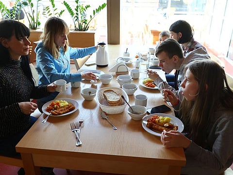 A family of Ukrainian refugees from Kharkiv and Zaporizhzhia, who have nowhere to go, eat lunch upon their arrival by bus from Przemysl to the International Youth Meeting Center, around two kilometres away from the former Auschwitz-Birkenau death camp, where they are provided with temporary accommodation, in Oswiecim, Poland, March 13, 2022.
