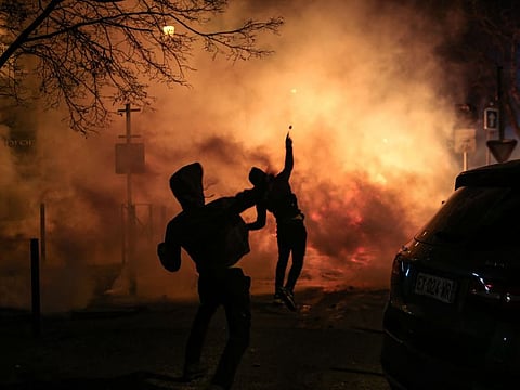 Protesters throws projectiles during clashes with police following a rally in support to Corsican nationalist figure Yvan Colonna a week after he was attacked in prison, in Bastia, Corsica, on March 13, 2022.