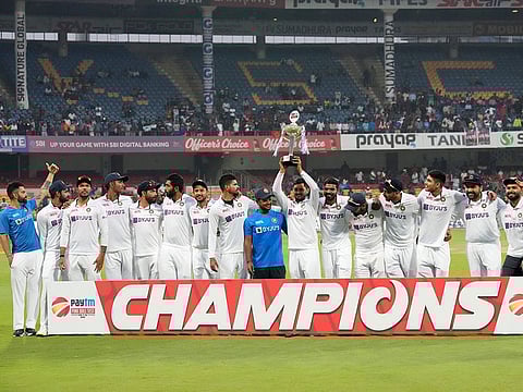 Indian players pose with the winners trophy after their win in the second cricket Test match against Sri Lanka in Bengaluru, on March 14, 2022. India won the series 2-0. 