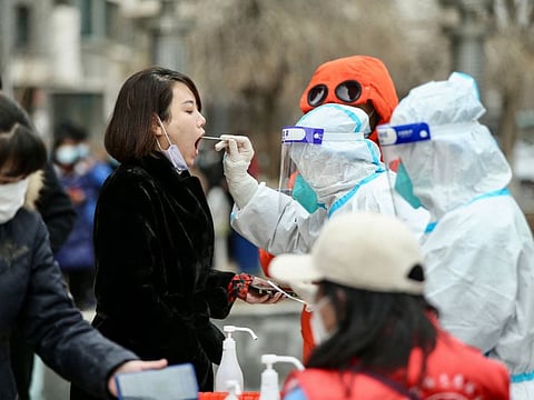 A resident undergoes a nucleic acid test for the COVID-19 in Shenyang, in China's northeastern Liaoning province. 