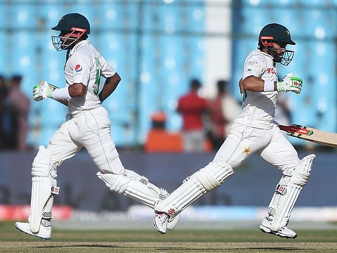 Marathon men: Babar Azam (left) and Mohammed Rizwan cross over during their match-saving partnership on Wednesday. 