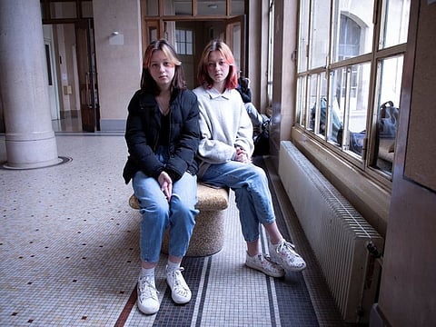 Ukrainian teenagers Sasha and Masha Litkovska at Jean de la Fontaine High School, after fleeing from Ukraine to France, following Russia's war in Ukraine, in Paris, France, March 17, 2022.