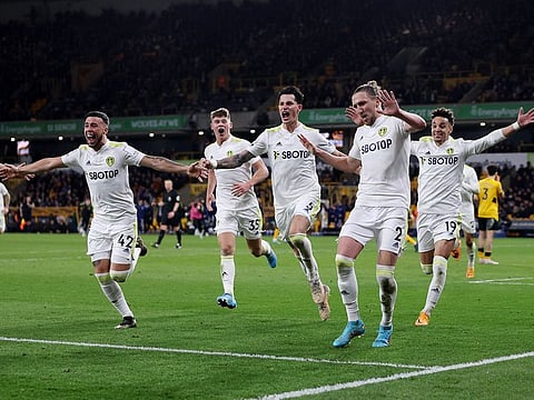 Leeds United's Luke Ayling celebrates scoring their third goal with teammates.