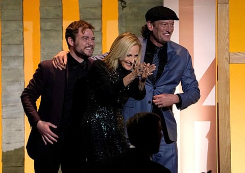 Daniel Durant, from left, Marlee Matlin and Troy Kotsur appear on stage as the producing team of "Coda" accepts the Darryl F. Zanuck Award for Outstanding Producer of Theatrical Motion Pictures at the 33rd annual Producers Guild Awards on Saturday, March 19, 2022, at the Fairmont Century Plaza Hotel in Los Angeles. 