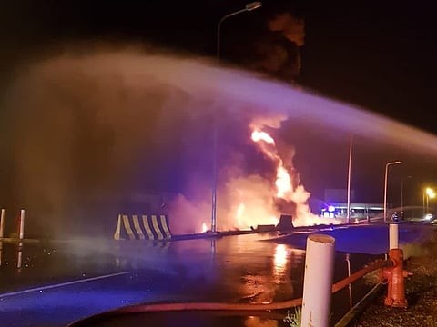 In this photo provided by the Saudi Press Agency, firefighters try to extinguish a blaze at an Aramco terminal in the southern border town of Jizan, Saudi Arabia, early Sunday, March 20, 2022.