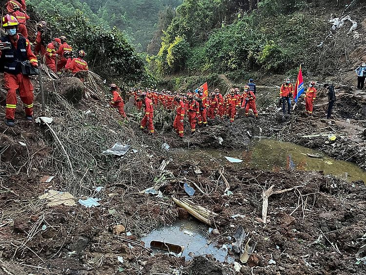Rescuers conduct search operations at the site of a plane crash in Tengxian County in southern China's Guangxi Zhuang Autonomous Region, on March 22, 2022.  