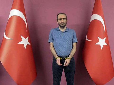 Selahattin Gulen, a nephew of US-based Muslim cleric Fethullah Gulen, stands between Turkish flags in this photo provided by Turkish intelligence service, on May 31, 2021.