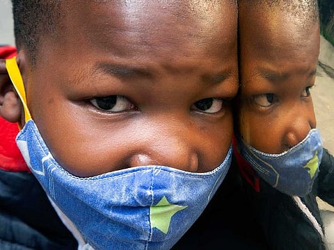 A child wears a face mask to protect against coronavirus at a Johannesburg Mall, in Johannesburg, Monday, Dec. 20, 2021. With declining cases of COVID-19, South Africa's president has announced that it is no longer mandatory to wear masks outdoors. 