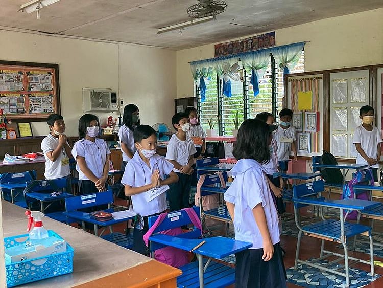 Filipino pupils show up for the morning flag ceremony for the first time Tuesday after the pandemic lockdown
