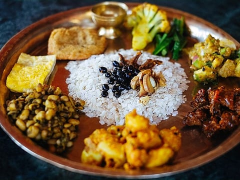 In Nepal, thali is a meal traditionally served on a brass plate, with various food items such as rice, dal (lentil), vegetables, homemade achar (pickles), and more.