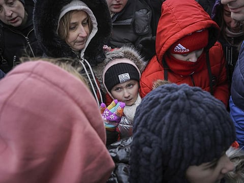 People, fleeing Ukraine, wait to board a bus which will take them at the train station in Przemysl, in the border crossing Medyka, Poland.