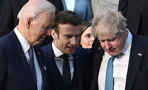(From right) Britain's Prime Minister Boris Johnson, France's President Emmanuel Macron and US President Joe Biden talk as they arrive at Nato Headquarters in Brussels on March 24, 2022. 