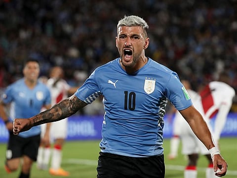 Uruguay's Giorgian De Arrascaeta celebrates scoring the opening goal against Peru during a qualifying soccer match for the Fifa World Cup Qatar 2022 in Montevideo, Uruguay, Thursday, March 24, 2022.