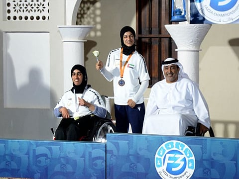 Noura Alketbi (left) and Thekra Alkaabi with Theban Salem Almuhairi, Secretary General of UAE Paralympic Committee on the podium.