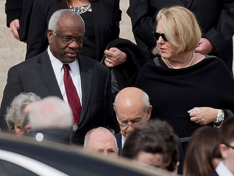 Supreme Court Associate Justice Clarence Thomas, left and his wife Virginia Thomas, right, leave the the Basilica of the National Shrine of the Immaculate Conception in Washington after attending funeral services of the late Supreme Court Associate Justice Antonin Scalia, on Feb. 20, 2016.